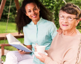 caregiver and senior woman reading
